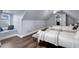 Bedroom featuring hardwood floors, bench seat under the window, and three beds at 1730 Connecticut Ave, St Cloud, FL 34769
