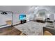 Large bedroom with hardwood floors, television, sofa, and a queen size bed at 1730 Connecticut Ave, St Cloud, FL 34769