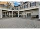 Serene courtyard with stone pavers, graceful columns, and ample space for outdoor entertaining at 1730 Connecticut Ave, St Cloud, FL 34769