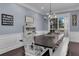 Dining room with an elegant chandelier, rustic decor, and a large table with bench seating at 1730 Connecticut Ave, St Cloud, FL 34769