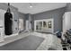 Open-plan exercise room with workout equipment, punching bag, and backyard access at 1730 Connecticut Ave, St Cloud, FL 34769