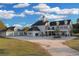 Spacious home with detached garage and a long driveway, set on a sprawling green lawn at 1730 Connecticut Ave, St Cloud, FL 34769