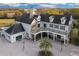 Stunning multi-story home with a large porch, beautiful landscaping, and a circular driveway at 1730 Connecticut Ave, St Cloud, FL 34769