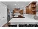 Spacious kitchen with white quartz counters, stainless steel appliances, dark wood cabinets, and center island at 1730 Connecticut Ave, St Cloud, FL 34769