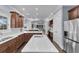 Open-concept kitchen featuring dark wood cabinets, white countertops, an island, and stainless steel appliances at 1730 Connecticut Ave, St Cloud, FL 34769