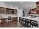 Eat-in kitchen showcasing white subway tile, custom dark wood cabinetry, and barstool seating at the kitchen island at 1730 Connecticut Ave, St Cloud, FL 34769