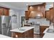 Gourmet kitchen with stainless steel appliances, dark wood cabinets, and a white tile backsplash at 1730 Connecticut Ave, St Cloud, FL 34769