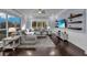 Bright living room with large windows, a ceiling fan, and dark hardwood floors at 1730 Connecticut Ave, St Cloud, FL 34769
