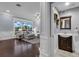 View of the living room through the entry to a powder room at 1730 Connecticut Ave, St Cloud, FL 34769