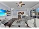 Open living space with view to kitchen, dark hardwood floors, and large sectional sofa at 1730 Connecticut Ave, St Cloud, FL 34769