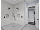 A modern walk-in shower featuring dual shower heads, sleek fixtures, tile and a glass door at 1730 Connecticut Ave, St Cloud, FL 34769