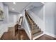 Hallway and staircase with wood floors, wrought iron railings, and natural light at 1730 Connecticut Ave, St Cloud, FL 34769