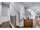 Staircase with wood and white stairs, wrought iron railing, and a safety gate at 1730 Connecticut Ave, St Cloud, FL 34769