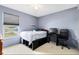 Bedroom with light blue walls, a full-size bed, and built-in storage at 290 Clydesdale Cir, Sanford, FL 32773