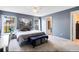 Main bedroom with gray walls, a king-size bed, and an ensuite bathroom at 290 Clydesdale Cir, Sanford, FL 32773