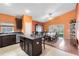 Kitchen features dark wood cabinets, an island, and stainless steel appliances at 290 Clydesdale Cir, Sanford, FL 32773