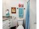 Contemporary bathroom featuring white cabinets, granite counters, and a blue-themed shower curtain that adds a pop of color at 2935 Antique Oaks Cir # 64, Winter Park, FL 32792