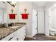 Well-lit bathroom with granite countertops, white cabinets, an updated shower and modern fixtures at 2935 Antique Oaks Cir # 64, Winter Park, FL 32792