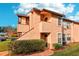 Two-story condo featuring mature landscaping and multiple windows at 2935 Antique Oaks Cir # 64, Winter Park, FL 32792