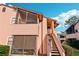 Charming exterior view of a two-story condominium with a screened porch and well-maintained landscaping at 2935 Antique Oaks Cir # 64, Winter Park, FL 32792