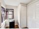 Bright hallway featuring a storage closet, window with decorative curtain, and wood-look flooring at 2935 Antique Oaks Cir # 64, Winter Park, FL 32792