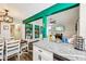 Bright kitchen featuring a granite countertop island, wood floors and modern appliances that opens to the living room at 2935 Antique Oaks Cir # 64, Winter Park, FL 32792
