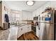 Bright, updated kitchen with granite counters, stainless appliances, and ample cabinet space for organized storage at 2935 Antique Oaks Cir # 64, Winter Park, FL 32792