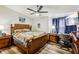 Cozy main bedroom with a woven bed frame, wood floors, and TV, bathed in soft, natural light from the window at 2935 Antique Oaks Cir # 64, Winter Park, FL 32792