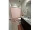 Bathroom with a granite countertop, decorative wall decals, and pink shower curtain at 3072 Cassidy Ln, Haines City, FL 33844