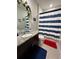 Bathroom featuring granite countertops, a vanity, and a blue and white striped shower curtain at 3072 Cassidy Ln, Haines City, FL 33844