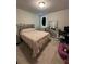 Bedroom featuring a bed with decorative headboard, dresser, and chair, creating a cozy retreat at 3072 Cassidy Ln, Haines City, FL 33844