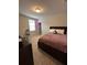 Bedroom with a queen bed, plush carpet, a window with blinds, and neutral paint at 3072 Cassidy Ln, Haines City, FL 33844
