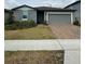 Charming single-story home with brick driveway, well-maintained landscaping, and a two-car garage at 3072 Cassidy Ln, Haines City, FL 33844