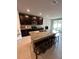 Spacious kitchen with a large island, granite countertops, stainless steel appliances, and dark wood cabinets at 3072 Cassidy Ln, Haines City, FL 33844