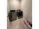 Laundry room with modern washer and dryer and tile flooring at 3072 Cassidy Ln, Haines City, FL 33844
