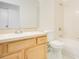 Bathroom features a wooden vanity with a sink, a toilet, and a bathtub with a shower head at 441 Tree Shore Dr, Orlando, FL 32825