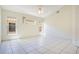 Bright, spacious bedroom with white tile flooring, multiple windows providing natural light, and fresh white walls at 441 Tree Shore Dr, Orlando, FL 32825