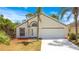 Charming single-story home featuring a two-car garage, arched entryway, and well-maintained landscaping at 441 Tree Shore Dr, Orlando, FL 32825