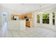 Bright eat-in kitchen boasts stainless steel appliances, wood cabinetry, and natural light from large windows at 441 Tree Shore Dr, Orlando, FL 32825