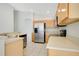 Functional kitchen featuring light wood cabinets, stainless steel appliances, and an efficient layout at 441 Tree Shore Dr, Orlando, FL 32825