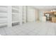 Open-concept living area showcasing built-in shelving, a kitchen view, and sliding glass doors for outdoor access at 441 Tree Shore Dr, Orlando, FL 32825
