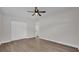 Bright bedroom with ceiling fan, double doors, and wood-look flooring at 4722 Halliday Ln, Orlando, FL 32810