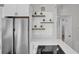 Modern kitchen with white cabinets and floating shelves at 4722 Halliday Ln, Orlando, FL 32810