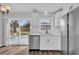 White kitchen cabinets, stainless steel appliances, and sliding door to backyard at 4722 Halliday Ln, Orlando, FL 32810