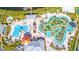Aerial view of a resort-style community pool area with winding waterways, lounge chairs and cabanas at 4731 Clock Tower Dr # 401, Kissimmee, FL 34746