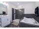 Elegant bathroom featuring a soaking tub, walk-in shower with glass enclosure, and double vanity sink at 4731 Clock Tower Dr # 401, Kissimmee, FL 34746