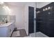 Modern bathroom featuring a large shower with dark tile and glass door, and a double vanity at 4731 Clock Tower Dr # 401, Kissimmee, FL 34746