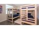 Cozy bedroom featuring two bunk beds with blue bedding and a soft area rug at 4731 Clock Tower Dr # 401, Kissimmee, FL 34746