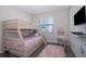 Light and airy bedroom with a bunk bed, TV, shag rug and soft decor at 4731 Clock Tower Dr # 401, Kissimmee, FL 34746