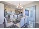 Elegant dining area with a glass table, modern chairs, and abundant natural light at 4731 Clock Tower Dr # 401, Kissimmee, FL 34746